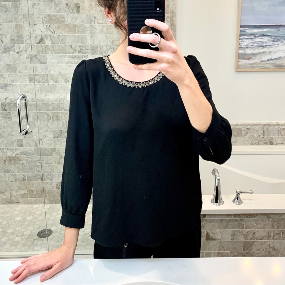 Blouse with beaded neckline